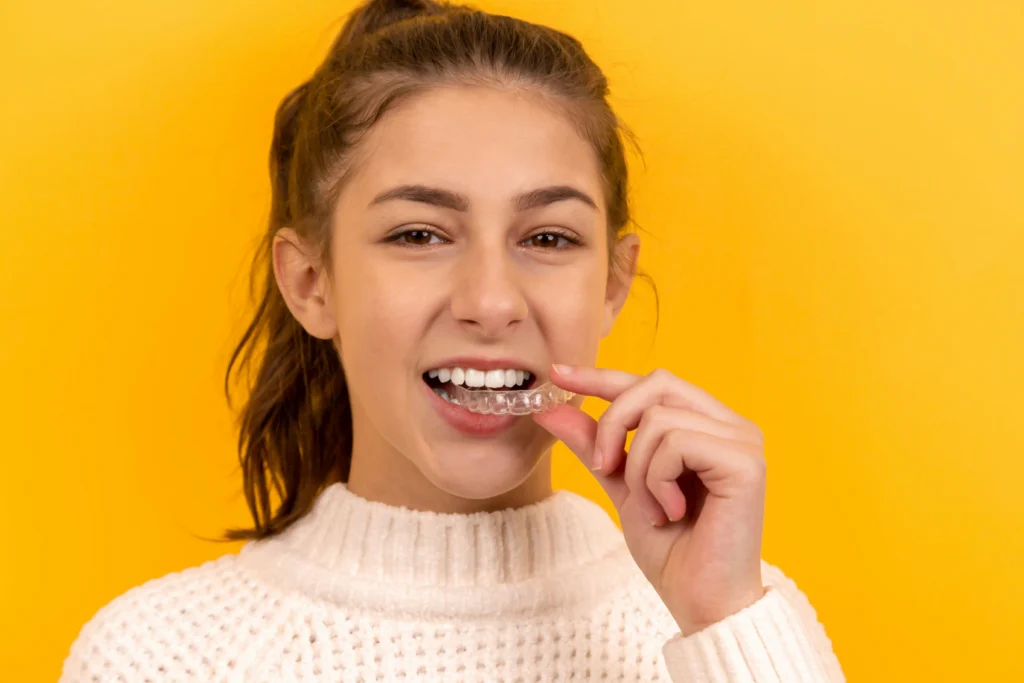Patient wearing clear dental aligners